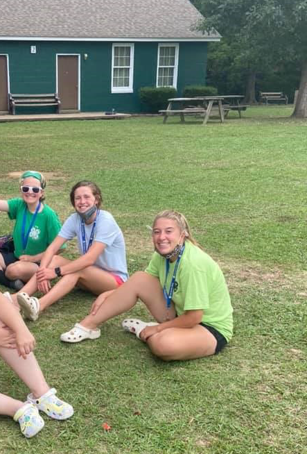 3 Teens sitting on grass smiling